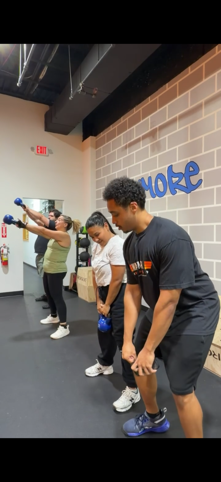 Adults training together in a group fitness class — campaign concept photography